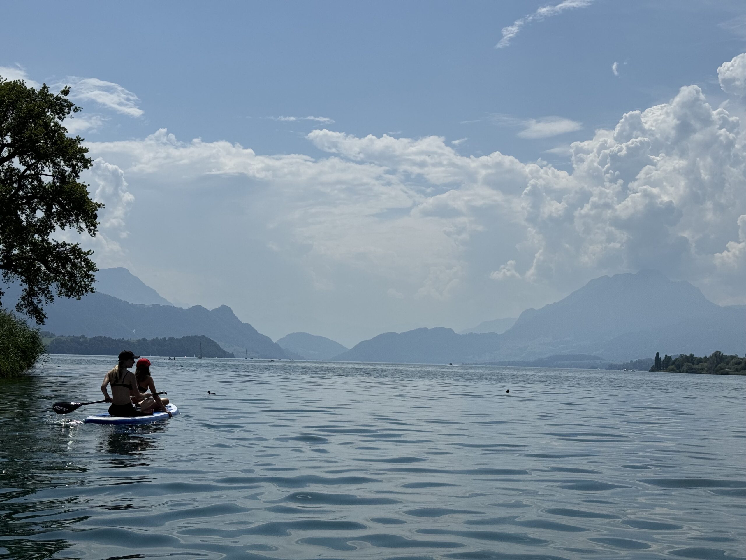 Me on a SUP overlooking part of my family on another SUP on Lake Lucerne